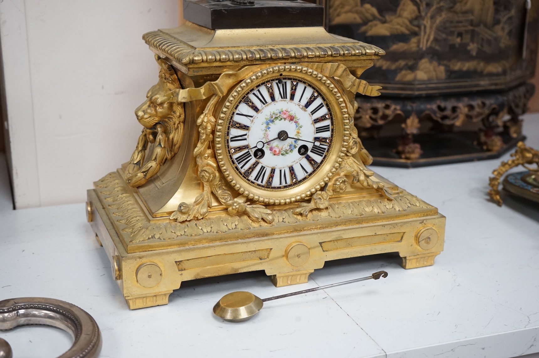 A 19th century French gilt bronze mantel clock, with classical figural surmount and floral painted dial, clock 54cm high.